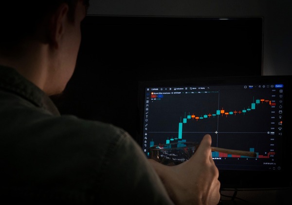Person working on a laptop reviewing crypto exchange operations